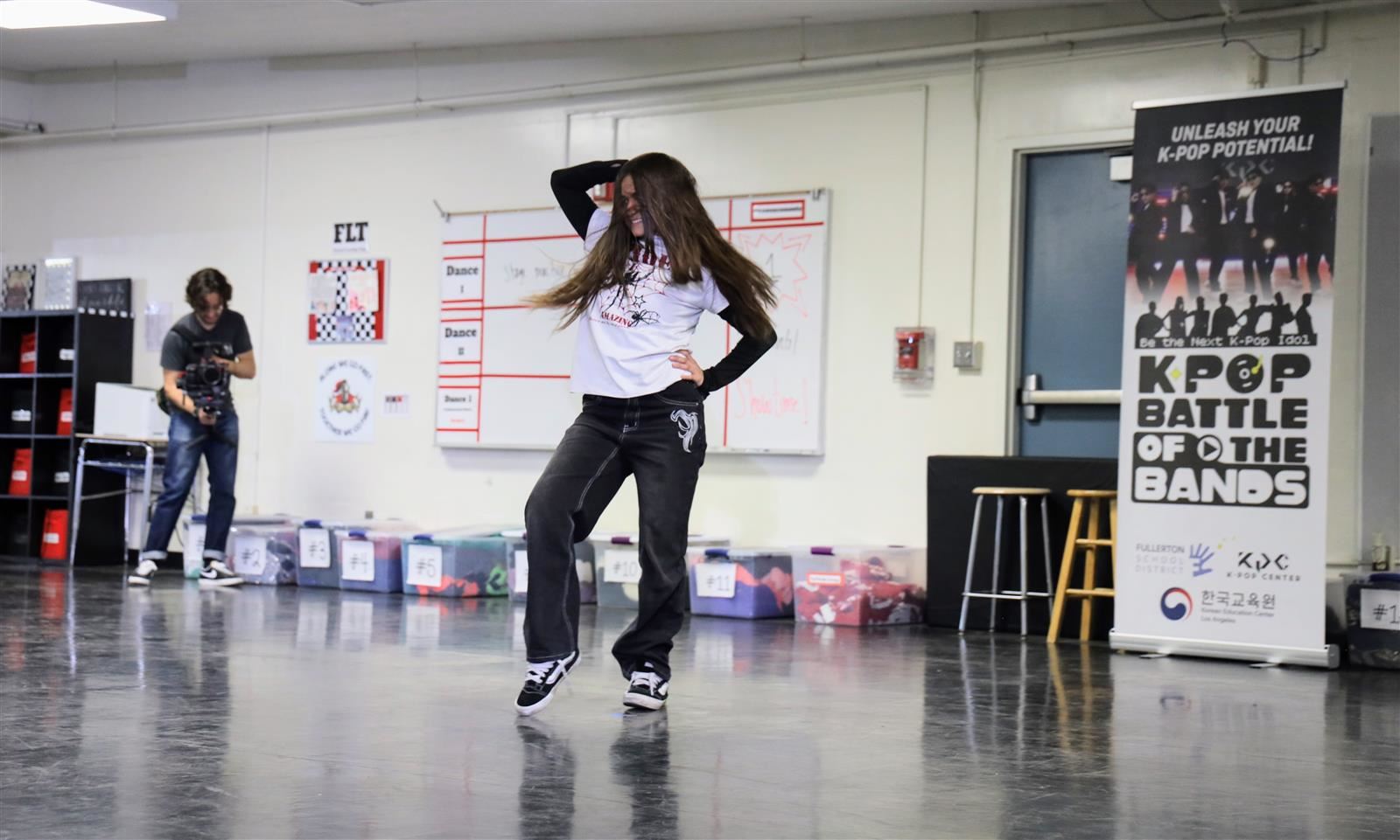 A Nicolas FSD K-Pop Battle of the Bands hopeful gives it her all as program documentarian Christian Lomeli grabs footage for 